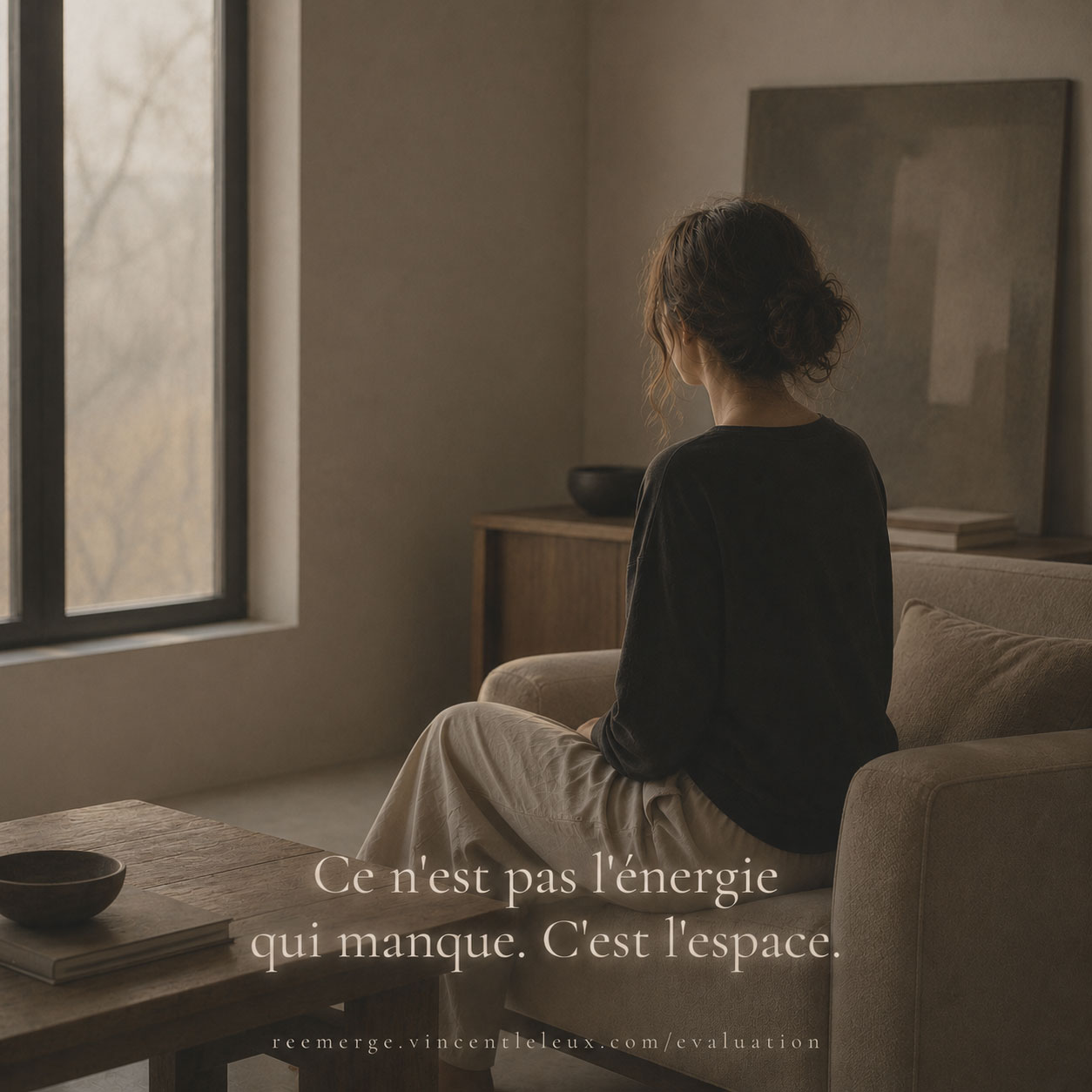 Woman seated on a sofa turned toward a window, Re-Emerge