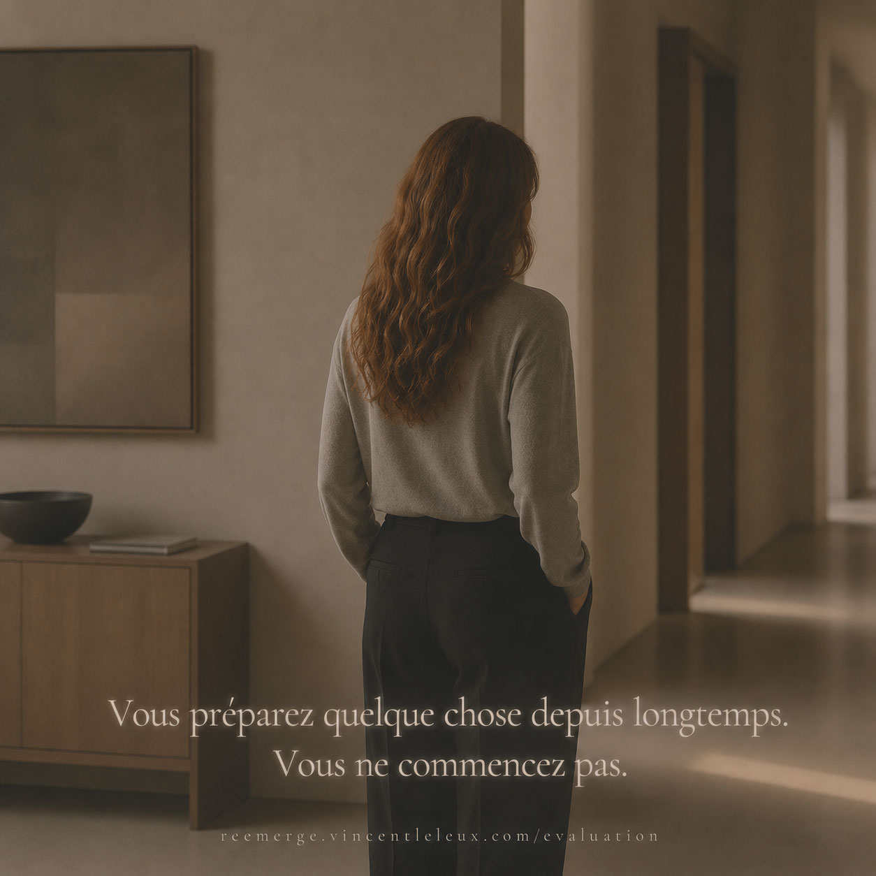 Woman with auburn hair standing in a corridor, Re-Emerge